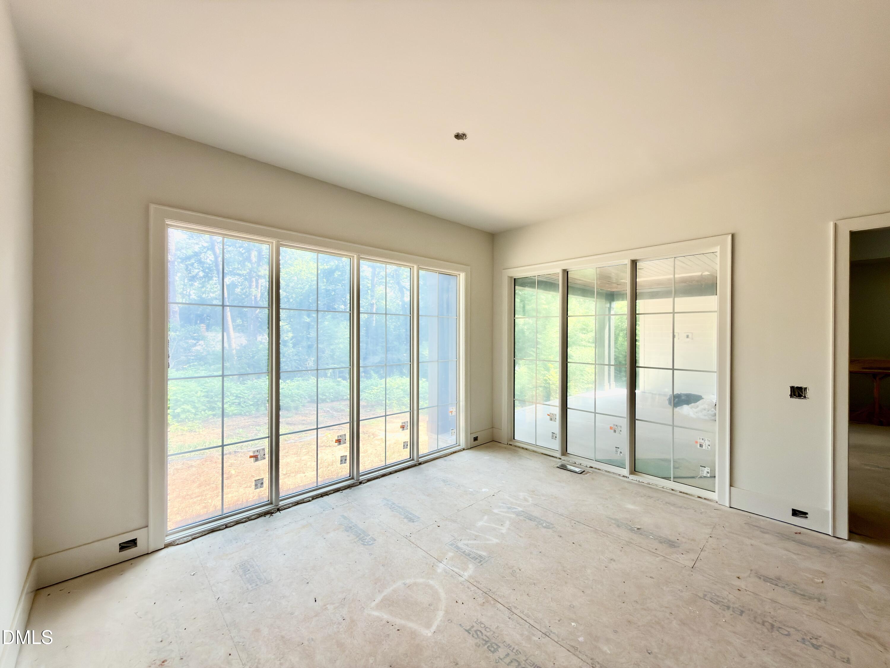 3422 Redbud Lane Raleigh, NC 27607 - Photo 19 of 59 a view of an empty room with a sliding door