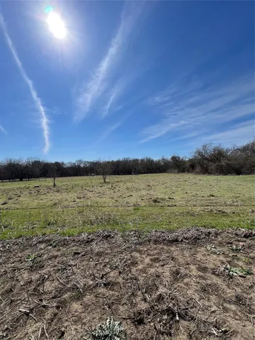 a view of a large body of water with a building in the background