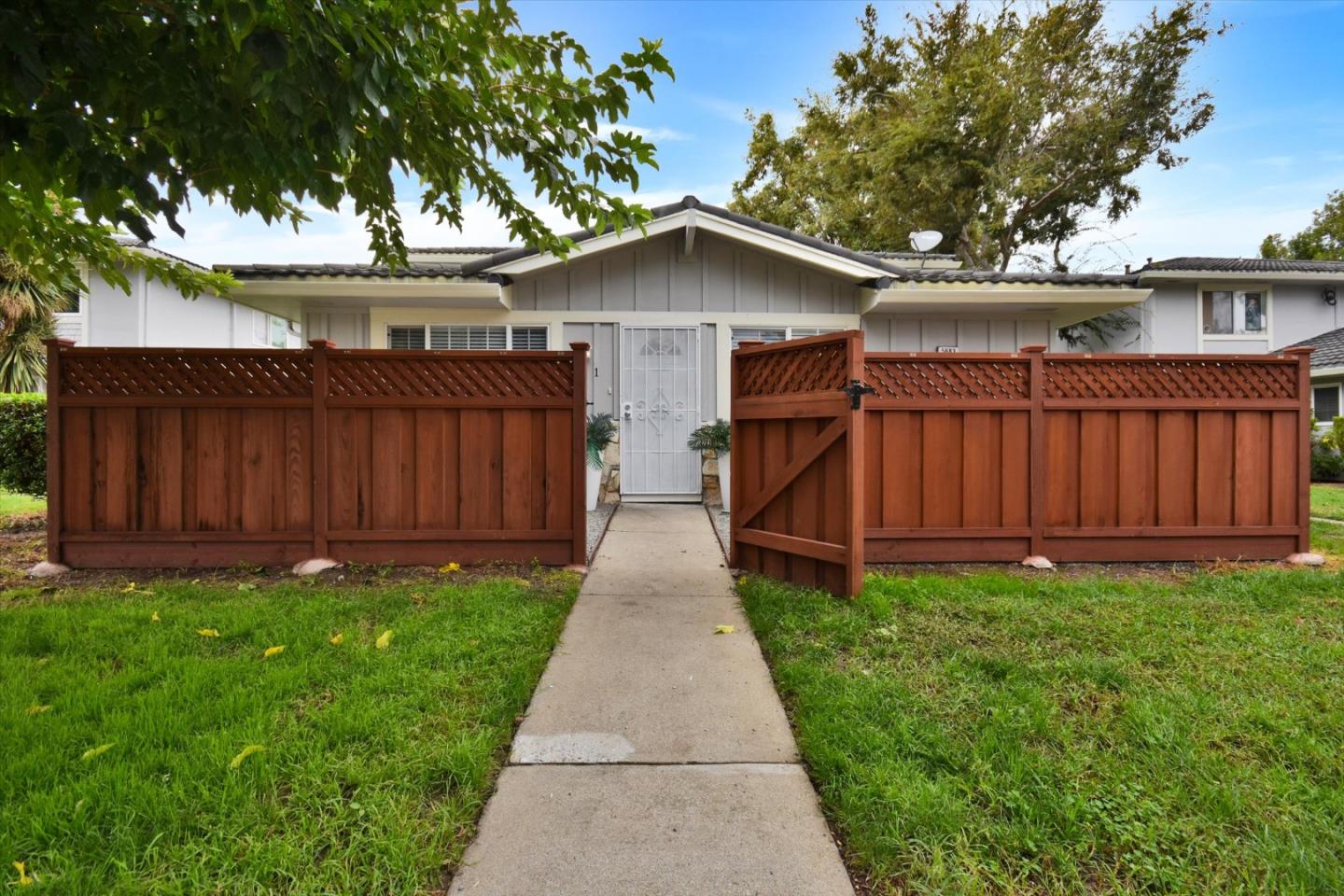 a view of a house with wooden fence