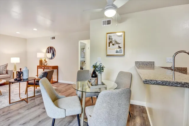 a dining room with furniture and wooden floor