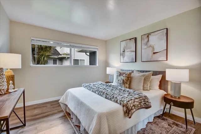 a bedroom with a bed and a lamp on table