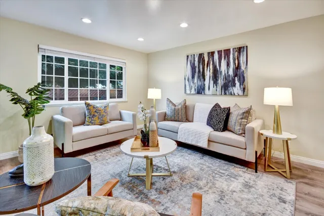 a living room with furniture and a potted plant