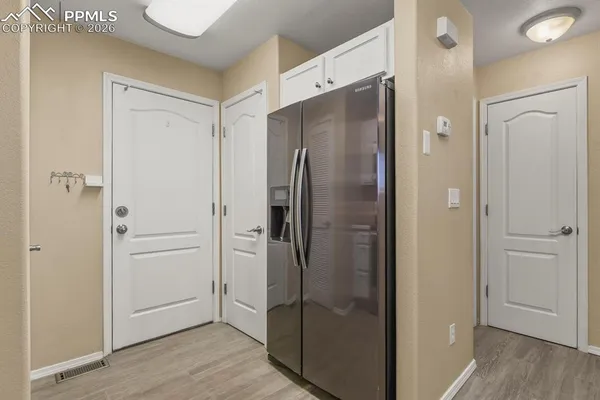 a bathroom with a glass shower door and a sink