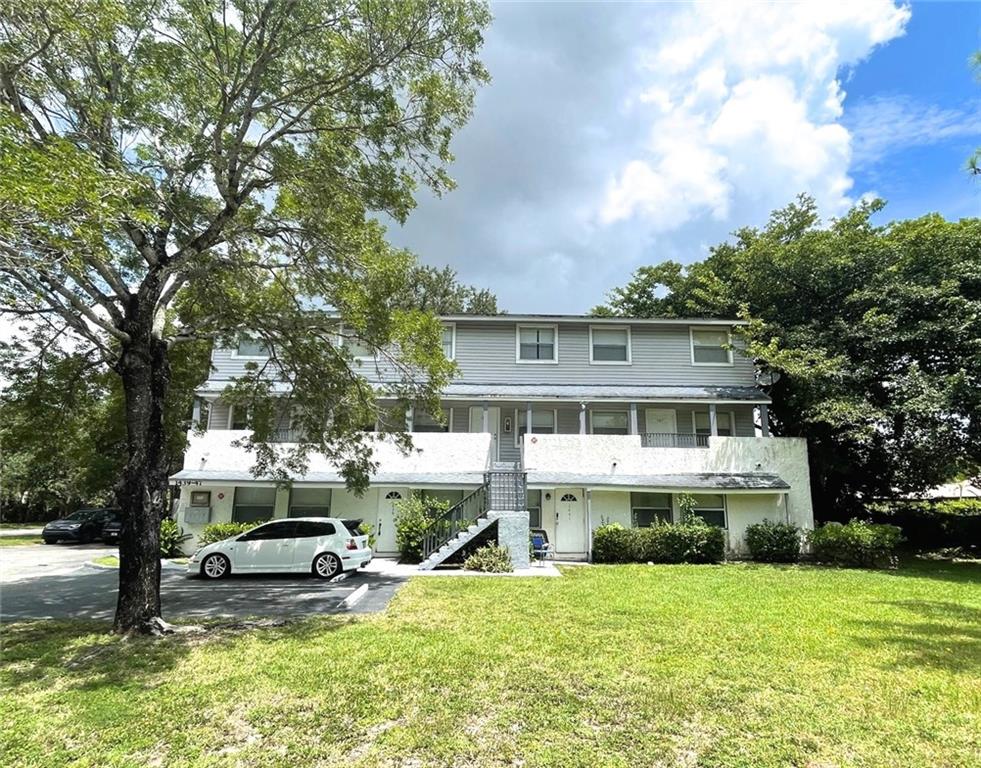 1439 Northwest 94th Way, Unit 1439 Coral Springs, FL 33071 - Photo 13 of 14 a view of a house with a big yard and large trees