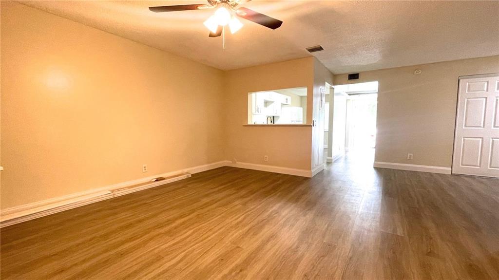 1439 Northwest 94th Way, Unit 1439 Coral Springs, FL 33071 - Photo 4 of 14 wooden floor in an empty room with a window
