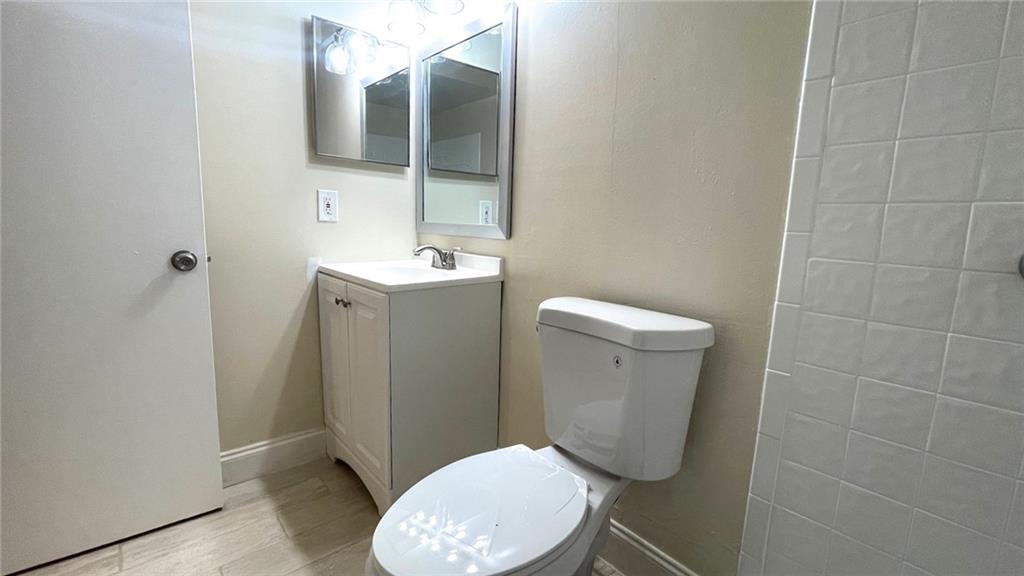 1439 Northwest 94th Way, Unit 1439 Coral Springs, FL 33071 - Photo 10 of 14 a bathroom with a toilet and a mirror