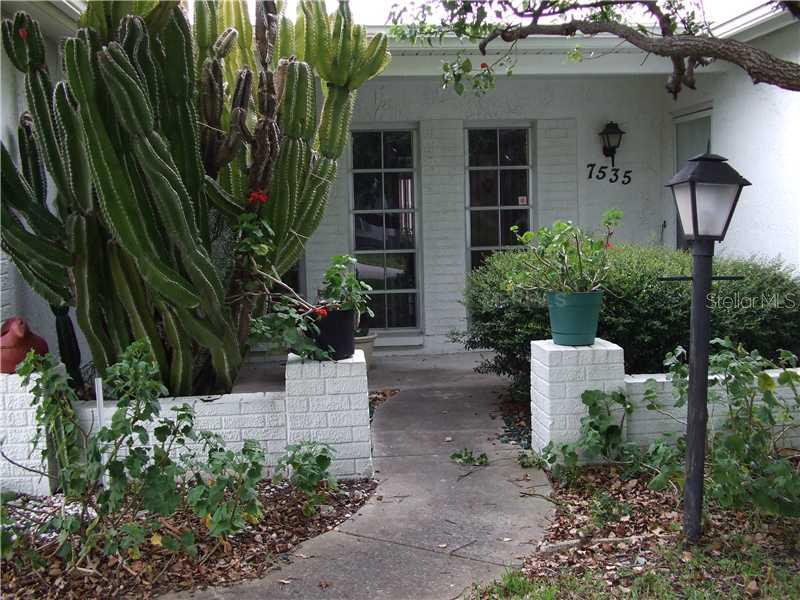 7535 Hawthorn Drive Port Richey, FL 34668 - Photo 1 of 1 a front view of a house with garden