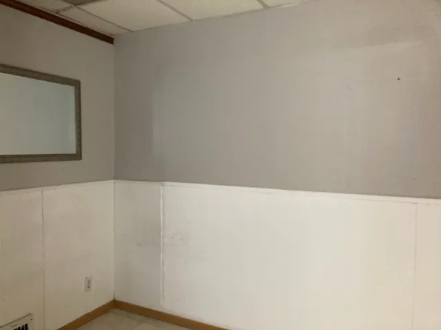 a white toilet sitting next to a white sink