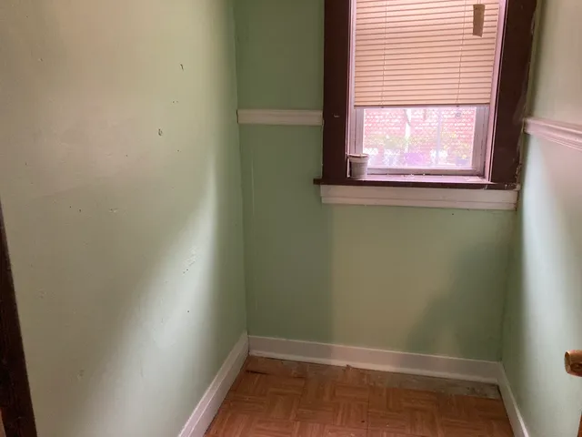 a view of a livingroom with a wall and potted plant