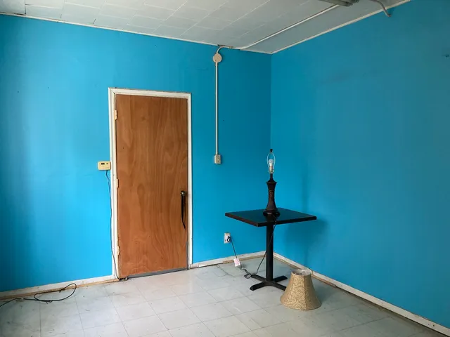 a view of a room with wooden floor and windows