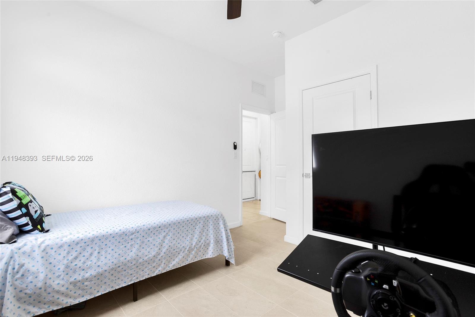 27440 Southwest 135th Ave Road Homestead, FL 33032 - Photo 15 of 75 a bedroom with a bed and a flat tv screen on the dresser