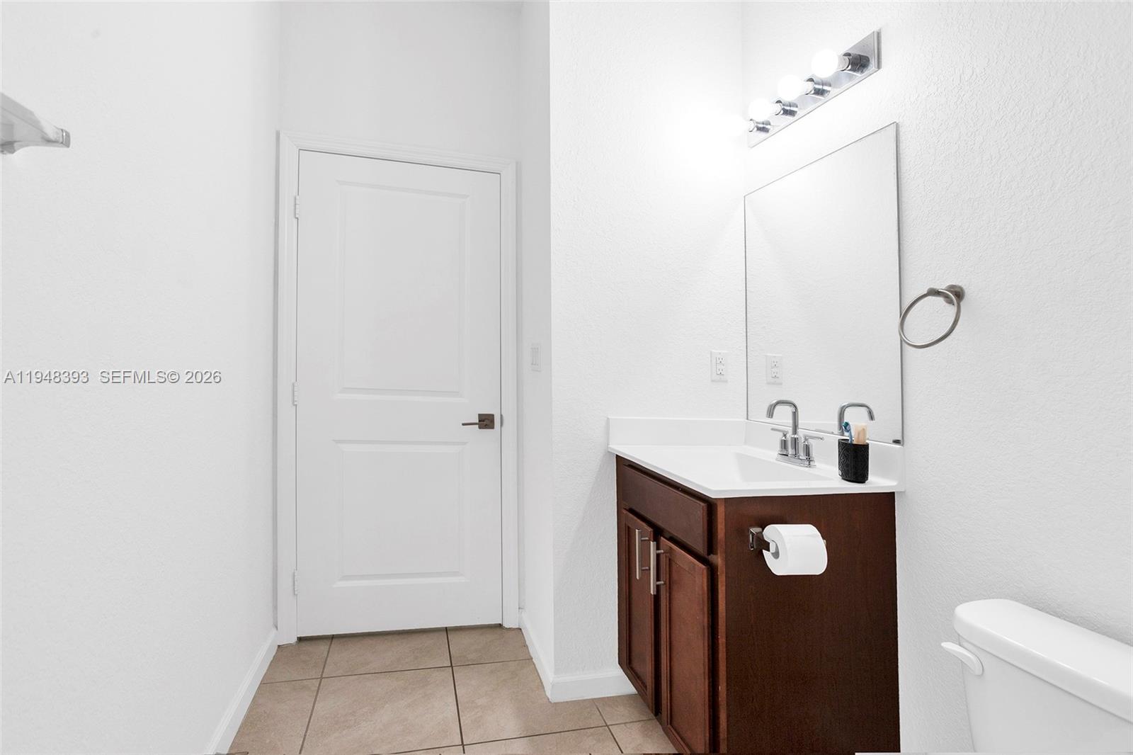 27440 Southwest 135th Ave Road Homestead, FL 33032 - Photo 18 of 75 a bathroom with a sink a toilet and mirror
