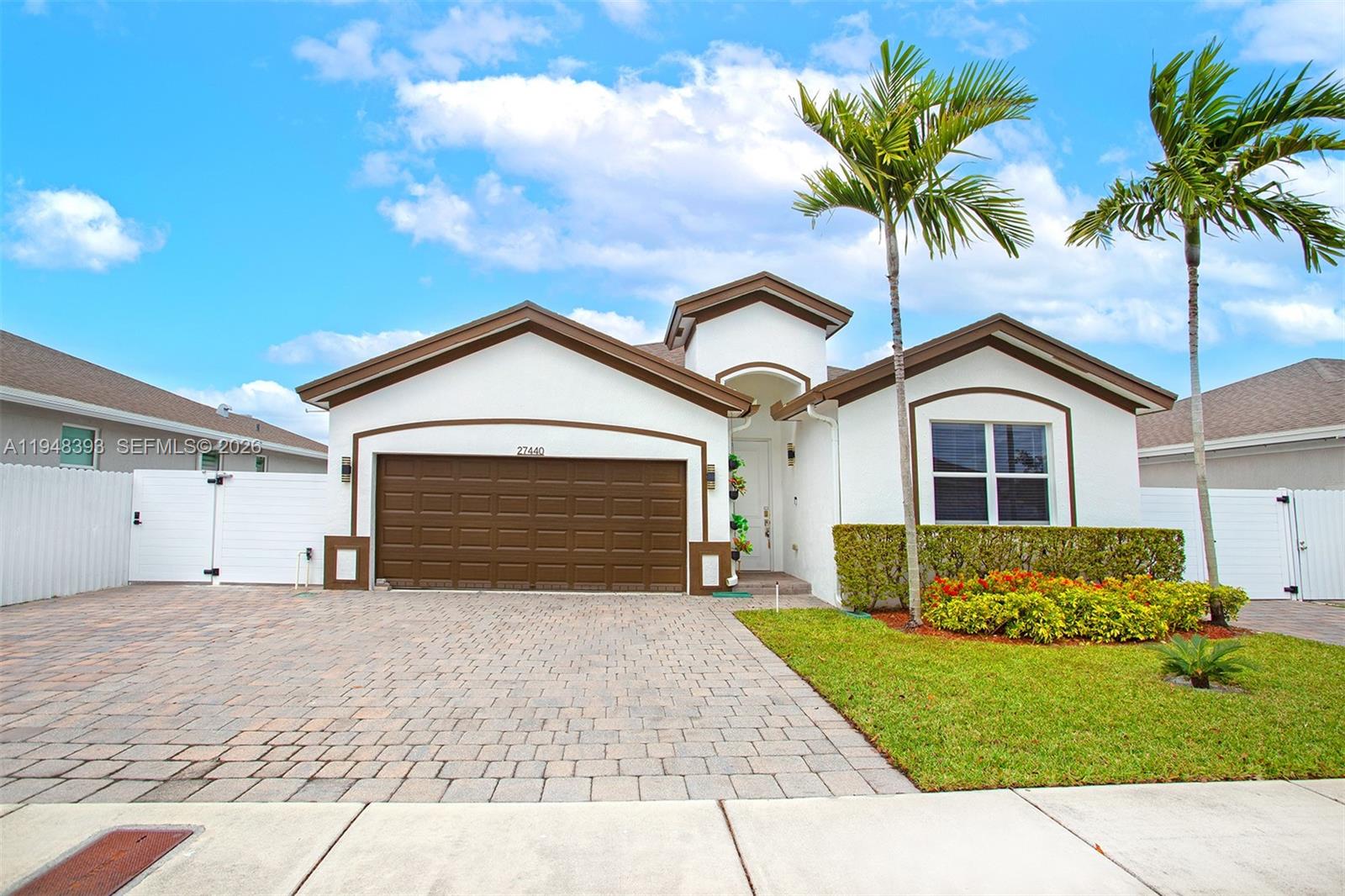 27440 Southwest 135th Ave Road Homestead, FL 33032 - Photo 20 of 75 a front view of a house with a yard and garage