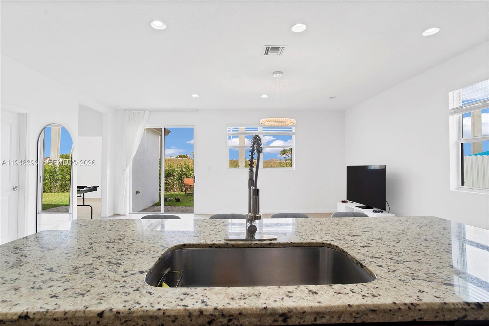 27440 Southwest 135th Ave Road Homestead, FL 33032 - Photo 2 of 75 a bathroom with a granite countertop sink and a large mirror