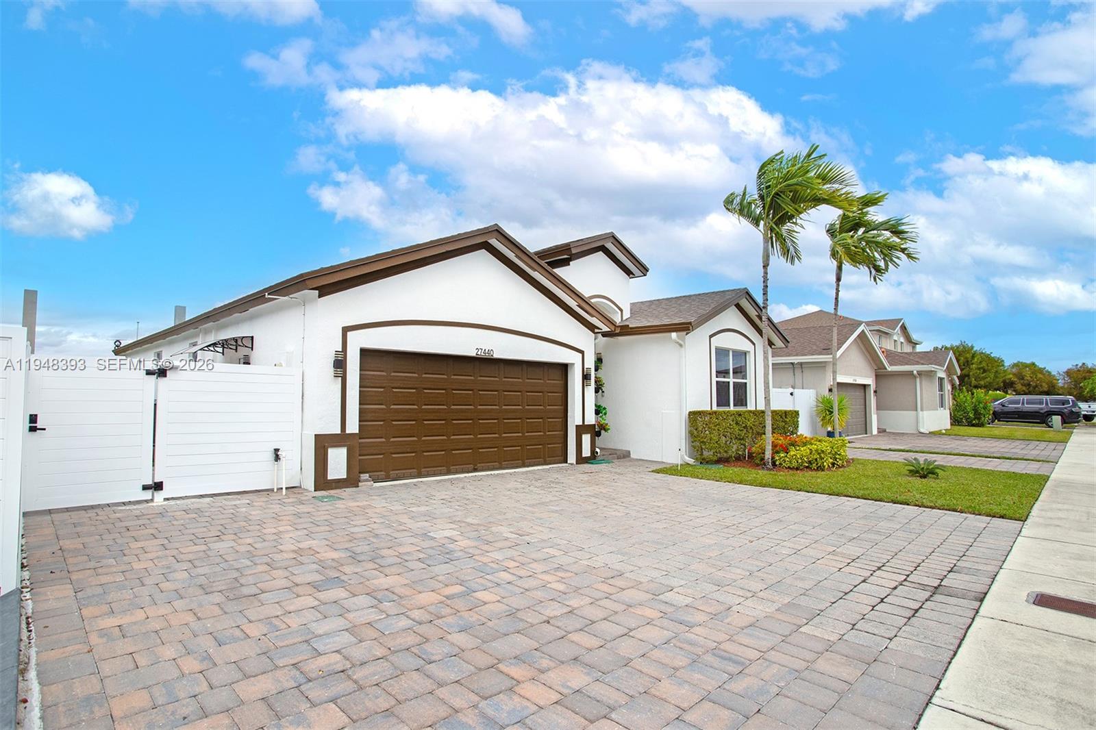 27440 Southwest 135th Ave Road Homestead, FL 33032 - Photo 21 of 75 a front view of a house with a yard and garage