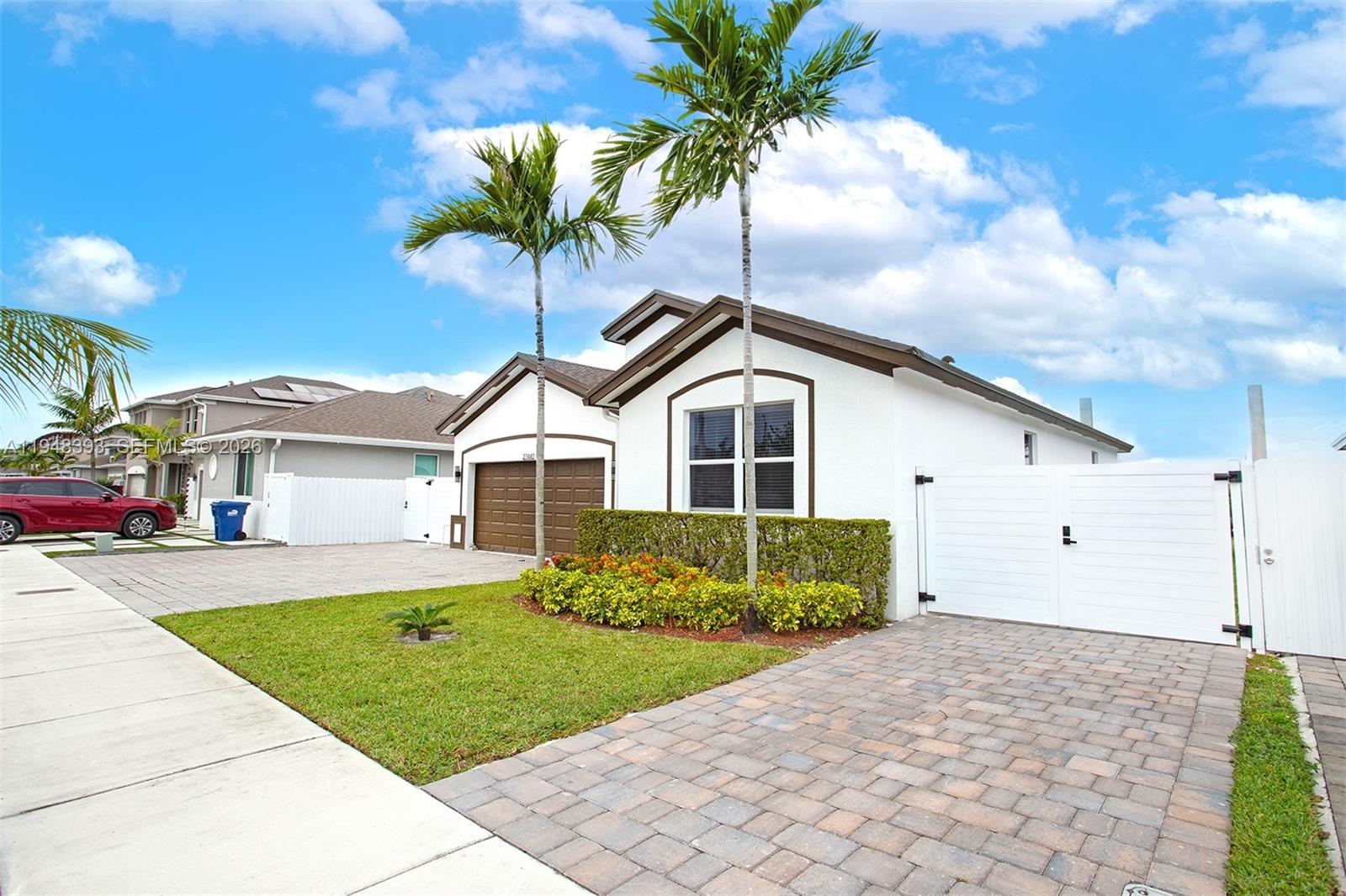 27440 Southwest 135th Ave Road Homestead, FL 33032 - Photo 23 of 75 a front view of a house with a yard and garage