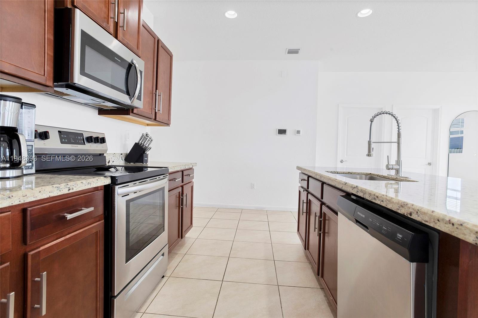 27440 Southwest 135th Ave Road Homestead, FL 33032 - Photo 40 of 75 a kitchen with stainless steel appliances granite countertop a sink and a stove