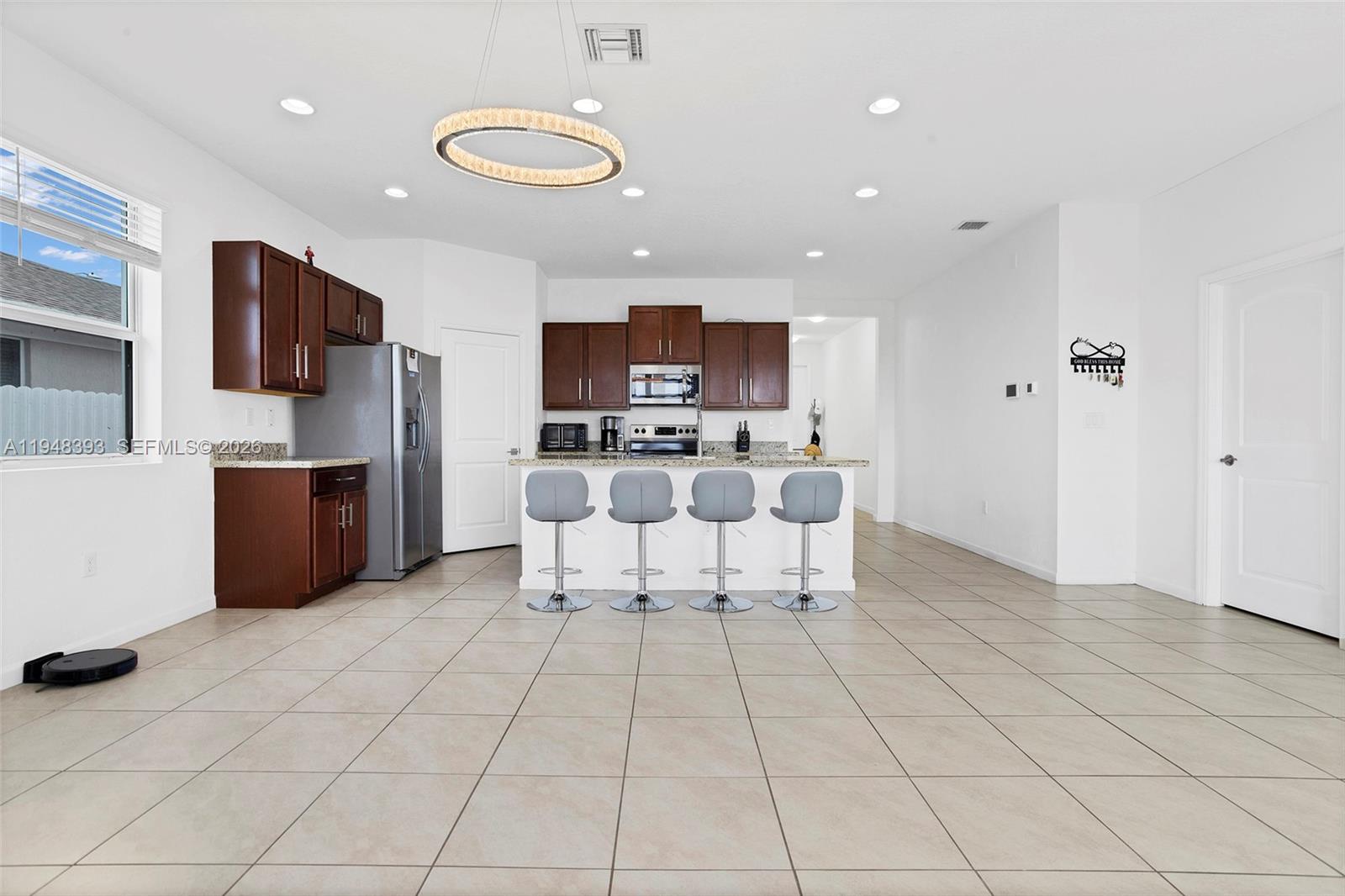 27440 Southwest 135th Ave Road Homestead, FL 33032 - Photo 42 of 75 a kitchen with stainless steel appliances a refrigerator and a stove top oven