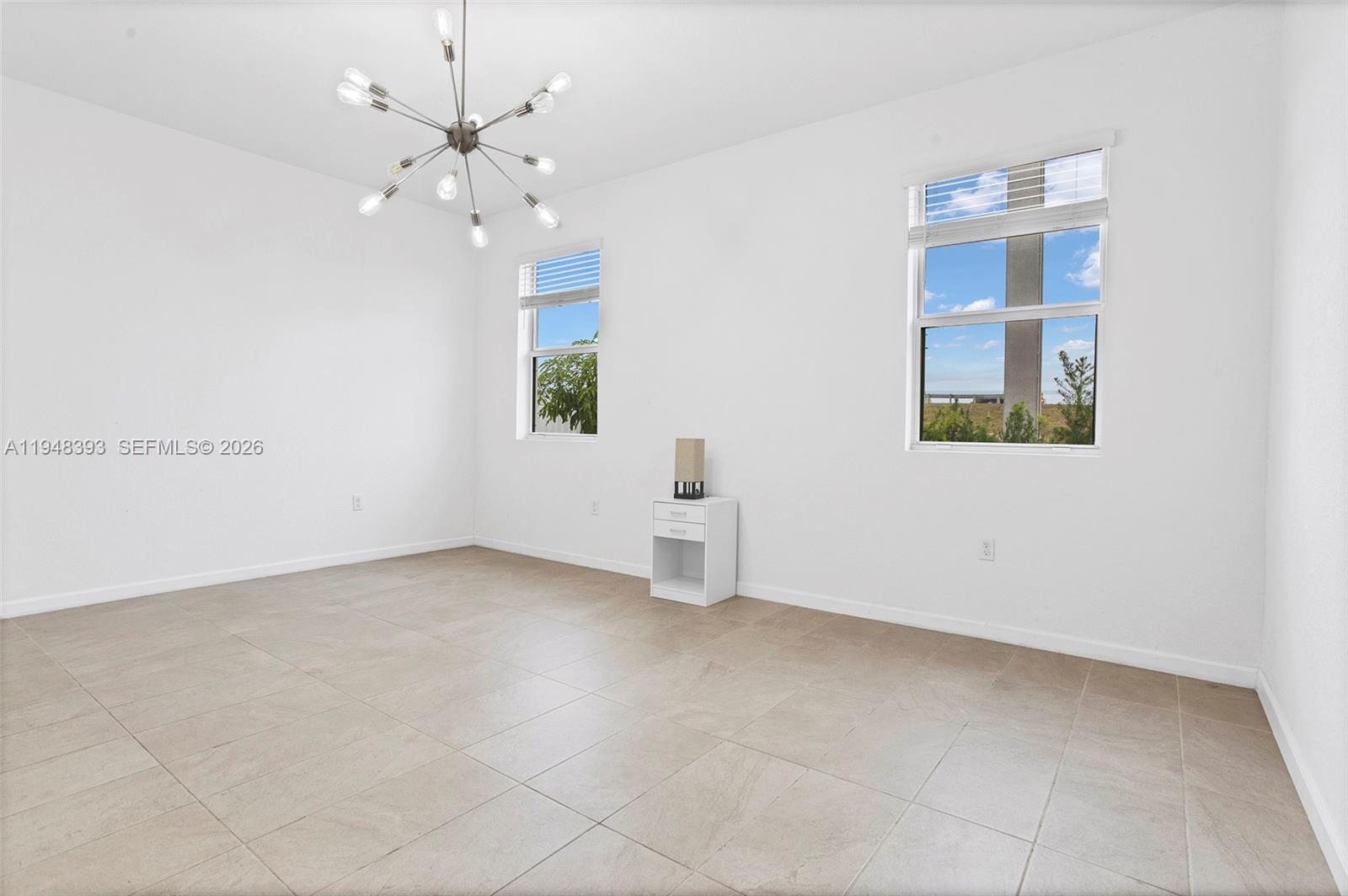 27440 Southwest 135th Ave Road Homestead, FL 33032 - Photo 48 of 75 an empty room with chandelier fan and windows