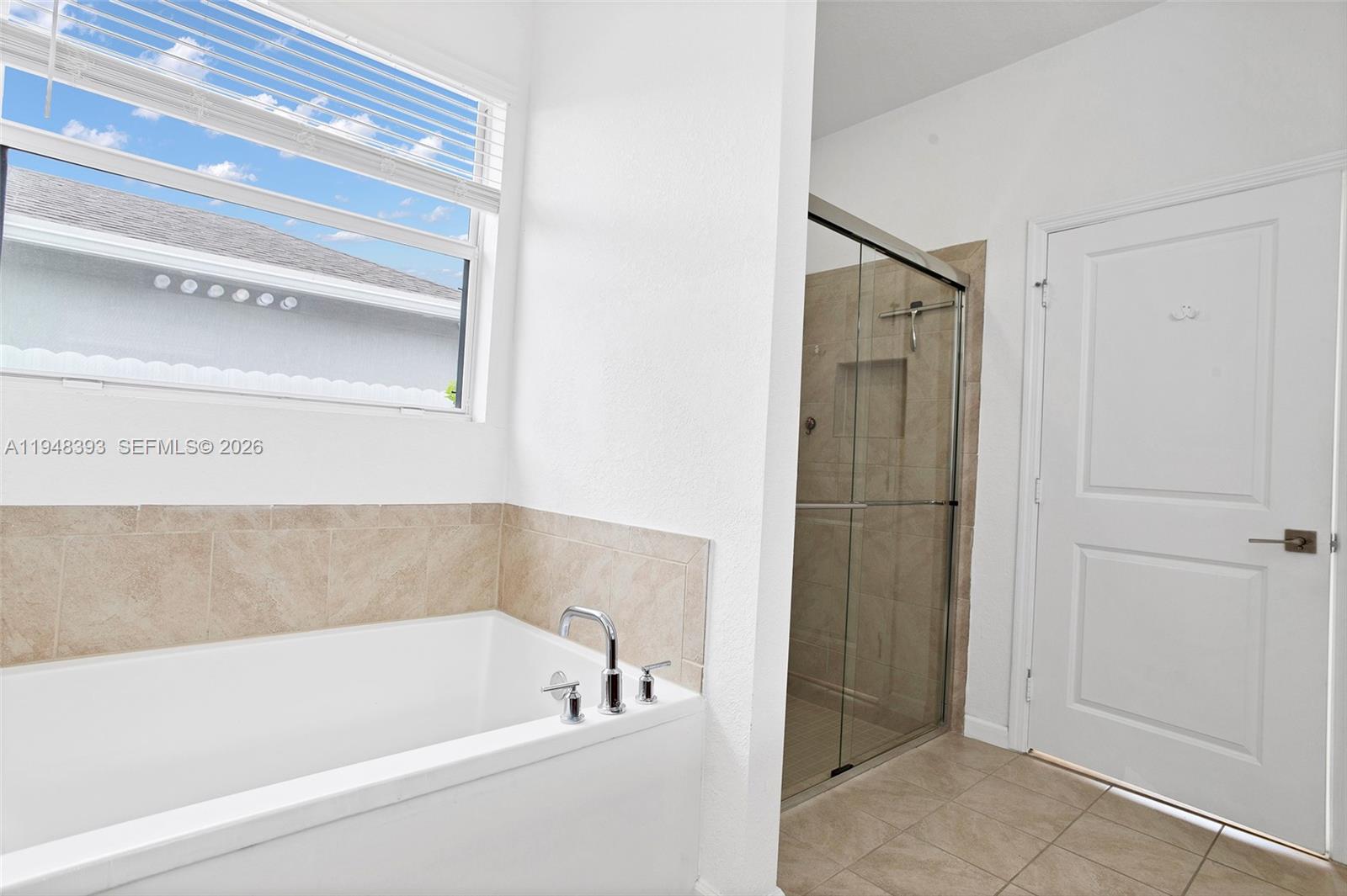 27440 Southwest 135th Ave Road Homestead, FL 33032 - Photo 51 of 75 a bathroom with a bathtub and shower