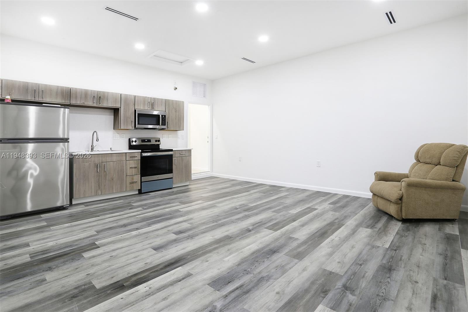27440 Southwest 135th Ave Road Homestead, FL 33032 - Photo 69 of 75 a view of kitchen with stainless steel appliances refrigerator stove microwave and cabinets