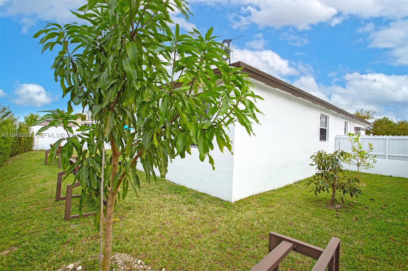 27440 Southwest 135th Ave Road Homestead, FL 33032 - Photo 7 of 75 a backyard of a house with lots of green space