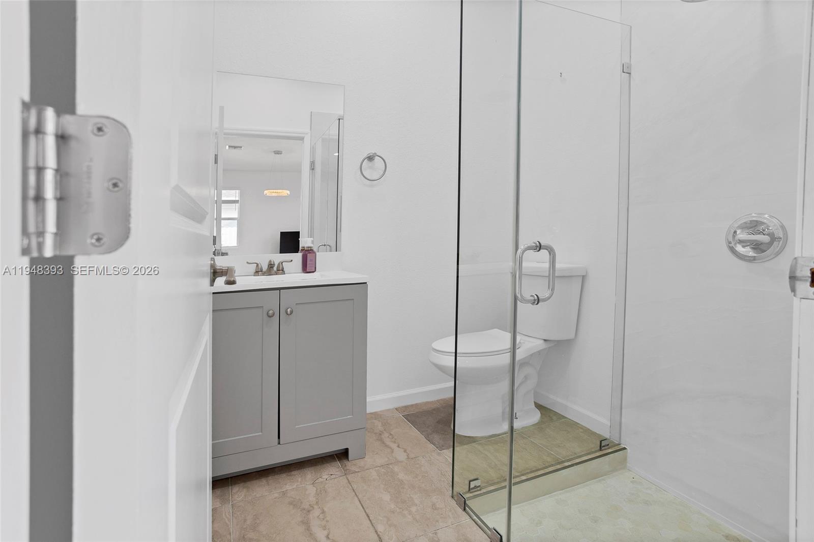 27440 Southwest 135th Ave Road Homestead, FL 33032 - Photo 9 of 75 a bathroom with a shower sink and mirror