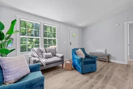 a view of a dining room with furniture and a potted plant