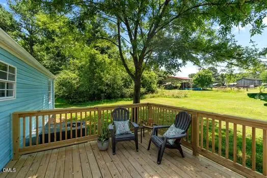 a view of a backyard with a garden and entertaining space
