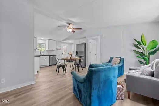 a view of a workspace room with furniture and a window