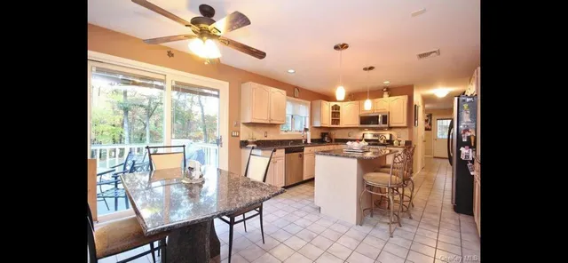 a kitchen with a table chairs and microwave