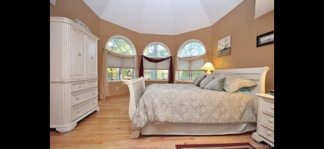 a bed room with a bed mirror and a window