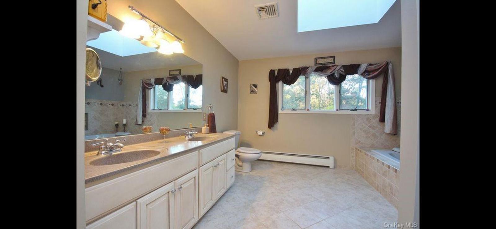 15 Ryder Court Stony Point, NY 10980 - Photo 22 of 31 a bathroom with a granite countertop sink mirror and a bathtub