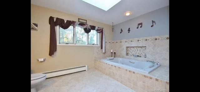 a bathroom with a tub sink and mirror