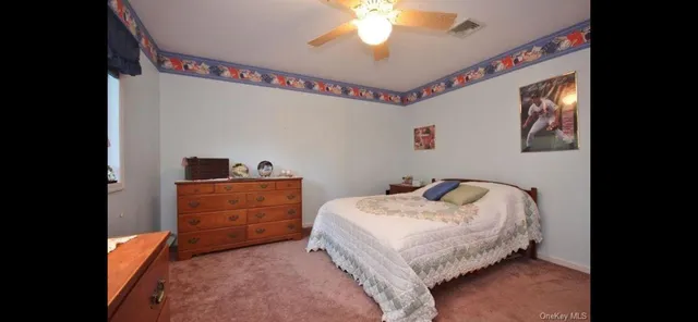 a bed room with a bed and a chandelier