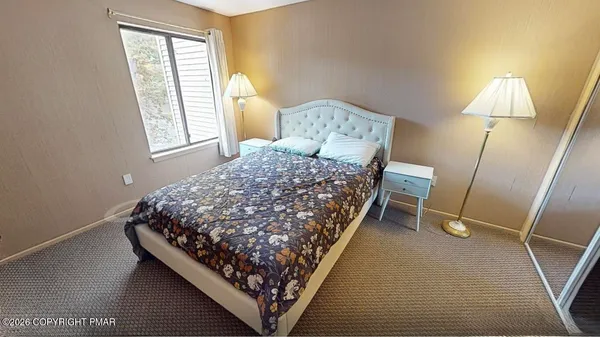 a bedroom with a bed and a mirror