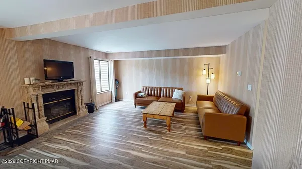 a living room with furniture and a fireplace or television