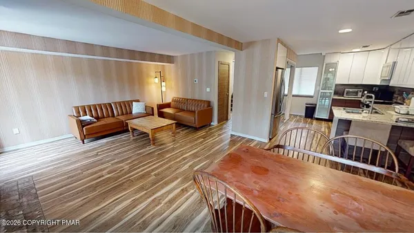 a living room with furniture and a wooden floor