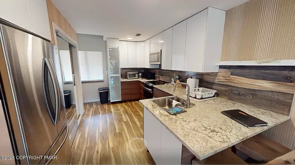 a kitchen with sink refrigerator and stove