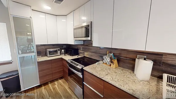 a kitchen with a sink and a stove top oven