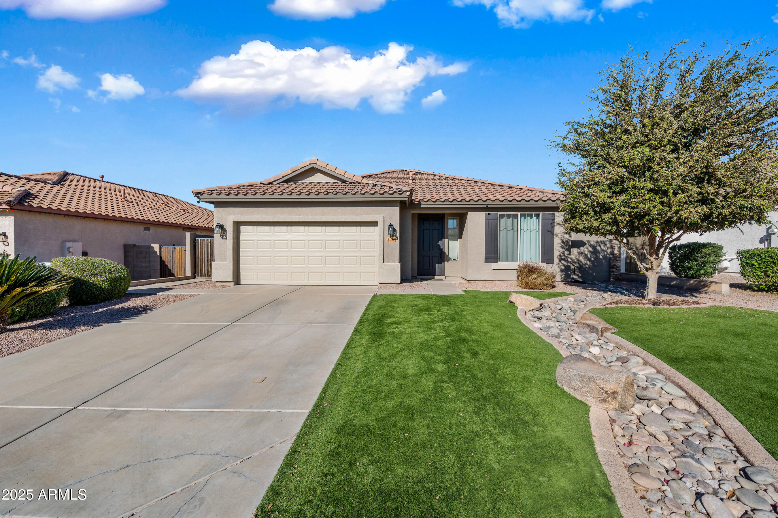 a front view of a house with a garden
