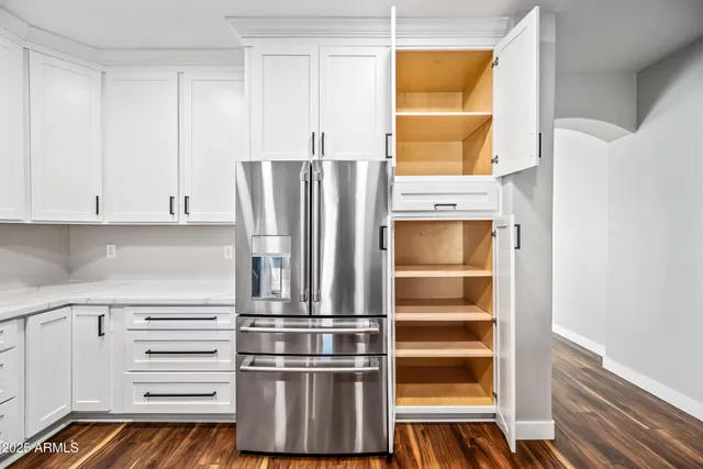 a view of walk in closet with empty racks