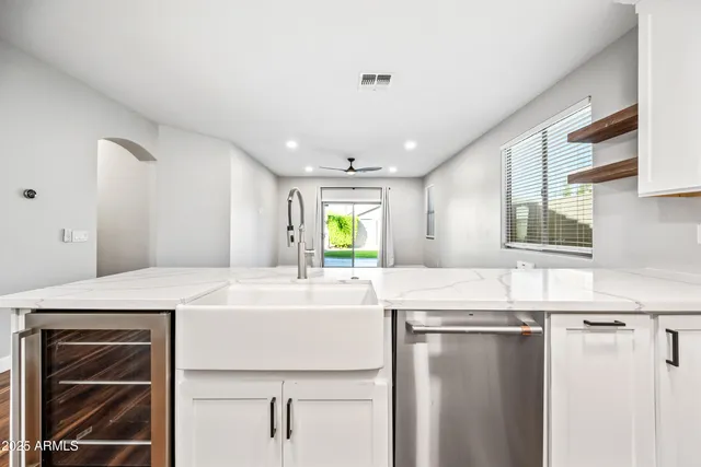 a kitchen with stainless steel appliances granite countertop a sink and a refrigerator