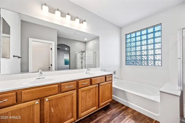 a bathroom with a tub a sink and mirror
