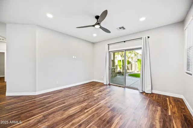 a view of an empty room with glass door
