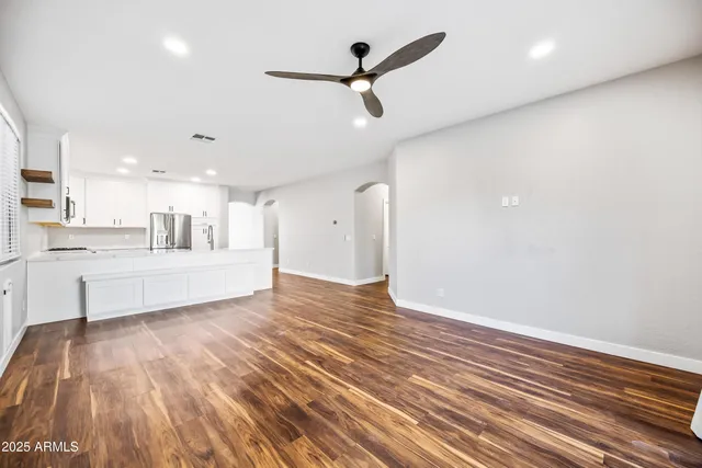 a view of a kitchen with wooden floor and a sink