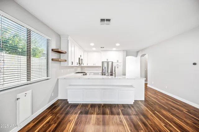 a view of kitchen with wooden floor and electronic appliances