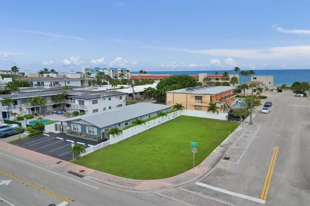 an aerial view of a house with garden space and street view