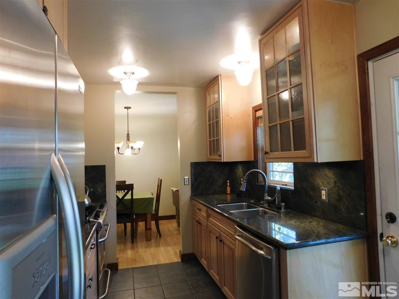 2001 Vale Street Reno, NV 89509 - Photo 7 of 16 a kitchen with granite countertop a sink stove and cabinets