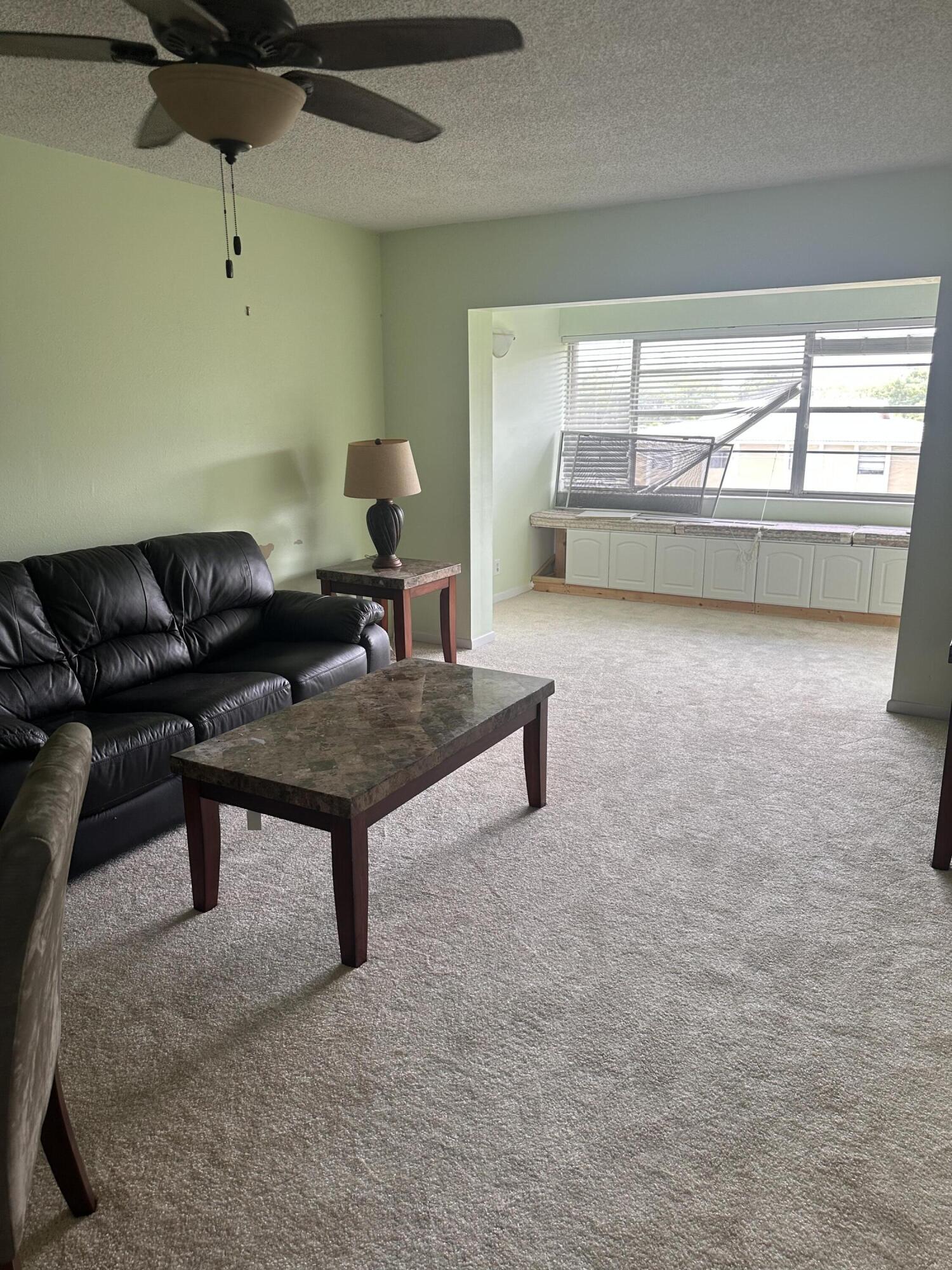 3090 Holiday Springs Boulevard, Unit 310 Margate, FL 33063 - Photo 14 of 26 a living room with furniture and a window